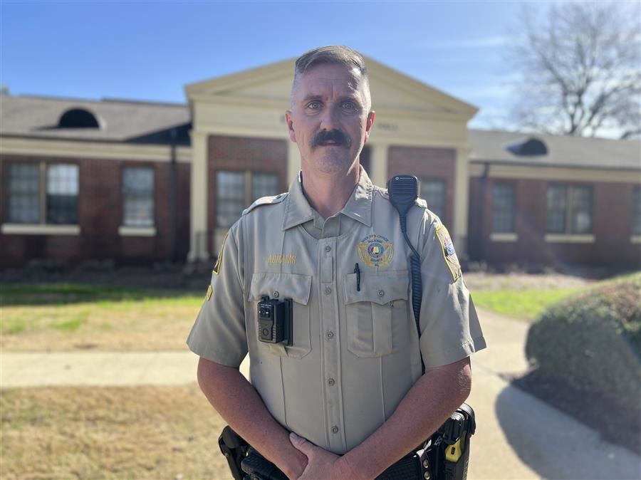  Deputy Abrams looks to camera.